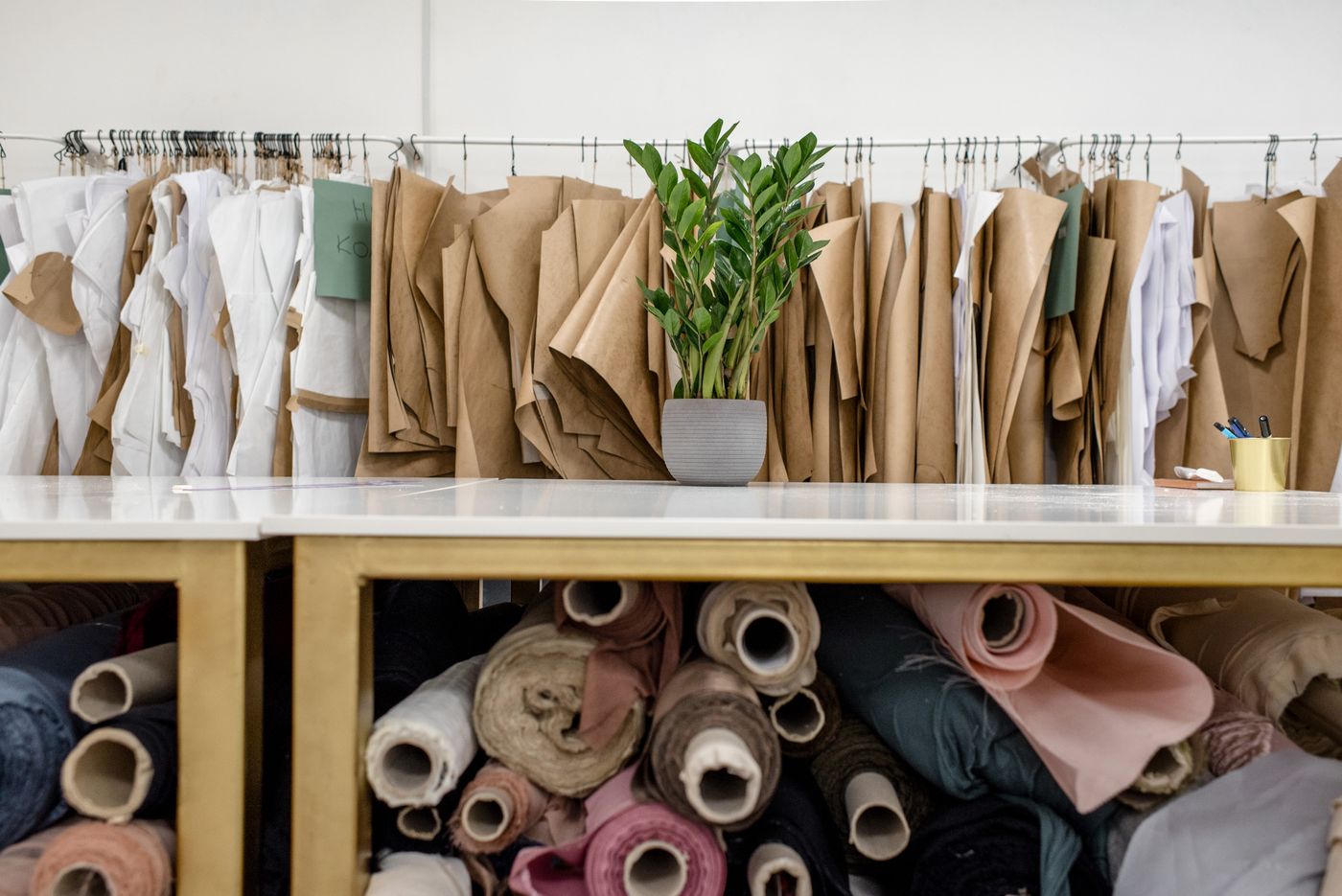 Bolts of fabric and paper patterns in a fashion atelier